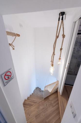 a staircase in a home with white walls and wood floors at La Casetta in Comacchio