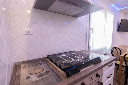 a kitchen with a stove and a counter top at La Casetta in Comacchio