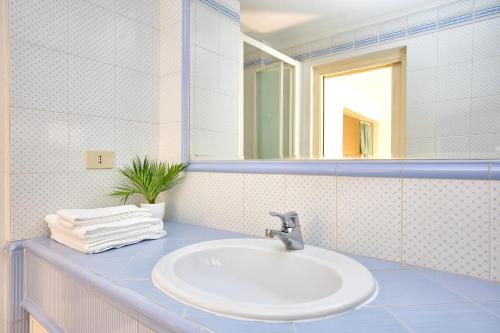 a bathroom with a sink and a mirror at Eternal Vatican Apartment EVA in Rome