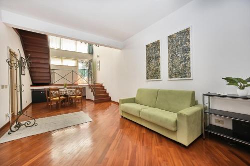 a living room with a couch and a table at Eternal Vatican Apartment EVA in Rome
