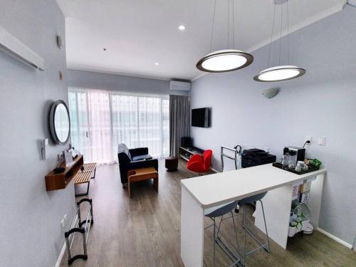 ein Wohnzimmer mit einem Tisch und Stühlen in einem Zimmer in der Unterkunft BRAND NEW! Modern amazing 1Bed - Princes Wharf in Auckland