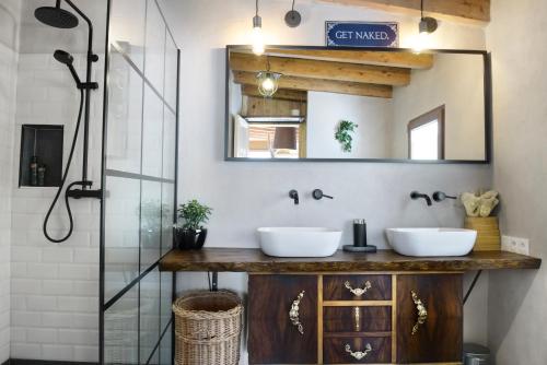 a bathroom with two sinks and a shower at Casa Mona- Andalucian mountain village getaway in Güéjar-Sierra
