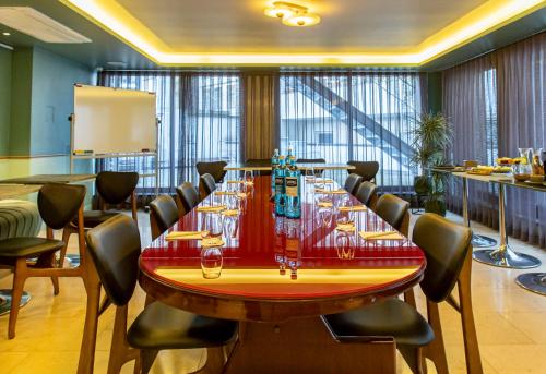 a conference room with a large table and chairs at MUZE Hotel Dusseldorf - Handwritten Collection in Düsseldorf