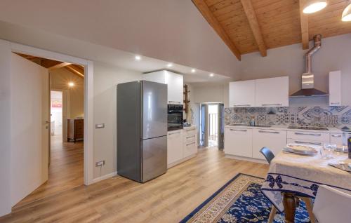 a large kitchen with a stainless steel refrigerator at Awesome Home In Albagnano Di Bee in Bee