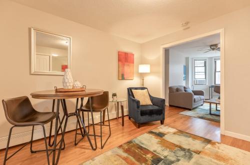 a living room with a table and chairs at Entire Apt Near Wharf in Boston