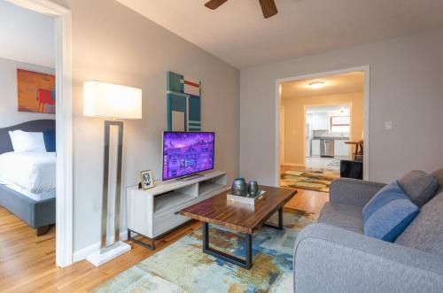 a living room with a couch and a tv at Entire Apt Near Wharf in Boston