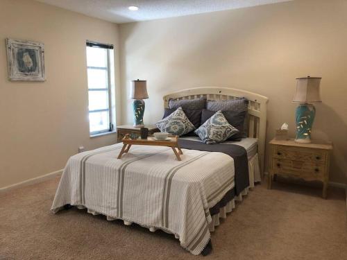 a bedroom with a large bed and a window at Spacious villa, pool, water views, walk to beach in West Palm Beach