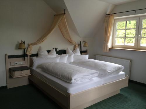 En eller flere senge i et værelse på Landhotel Menke