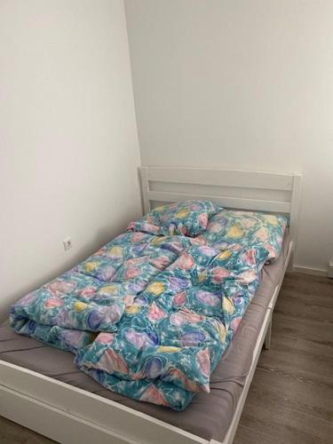 a bed with a comforter on it in a bedroom at Apartment 3 502 in Goslar