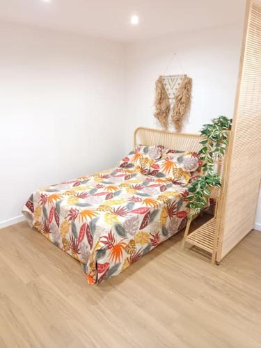 - un lit avec une couverture colorée dans l'établissement Charmant studio centre-ville Montpellier, à Montpellier