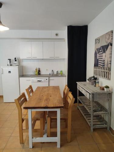 - une cuisine avec une table et des chaises en bois dans l'établissement La Brise du lac, à Sainte-Croix-de-Verdon