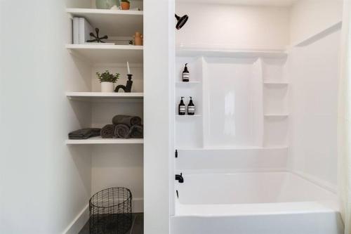 a white closet with white shelves at Willow A-Frame in New Iberia