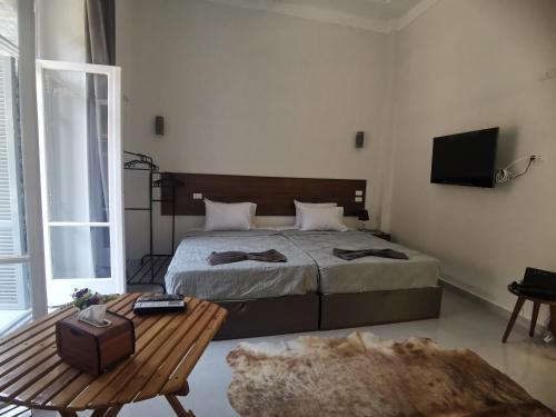 a bedroom with a bed and a table and a television at family suites cairo downtown in Cairo