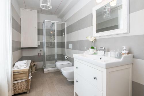 a bathroom with a white sink and a shower at La Vecchia Tenenza B&B in Città della Pieve