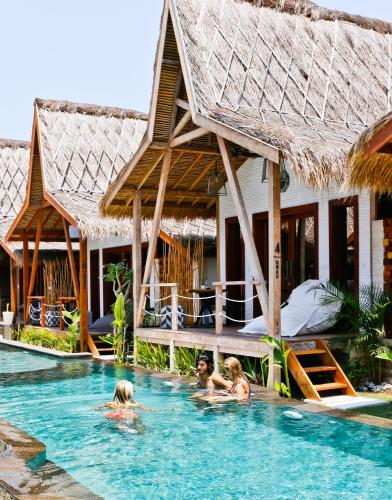 a group of people in the swimming pool at a resort at Kaleydo Villas in Gili Trawangan