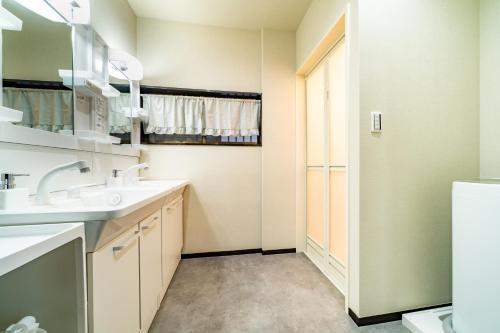 a bathroom with two sinks and a mirror at 72, Nakanobu A, Entire house for rent, 中延A in Tokyo