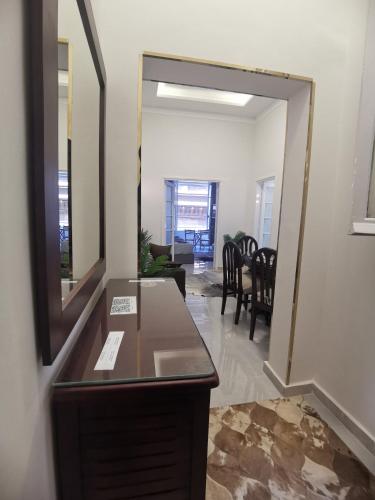 a mirror on a dresser in a living room with a table at family suites cairo downtown in Cairo