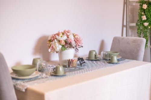a table with a table cloth and a vase of flowers at La Vecchia Tenenza B&B in Città della Pieve