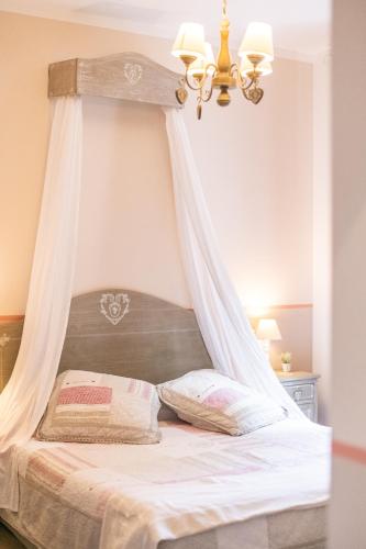 a bedroom with a bed with a canopy at La Vecchia Tenenza B&B in Città della Pieve