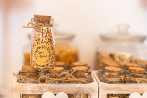 a jar filled with food next to other jars of food at La Vecchia Tenenza B&B in Città della Pieve