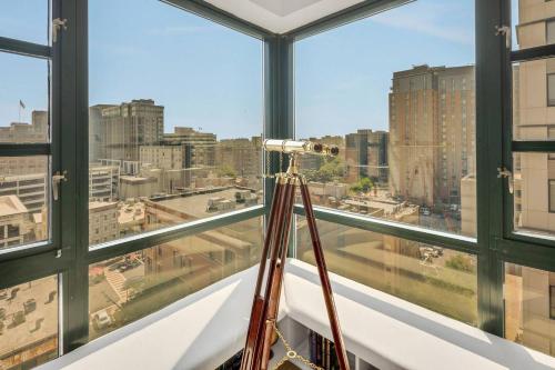 a camera in a room with a view of a city at Penthouse Perfection With Unmatched Skyline Views in Stamford