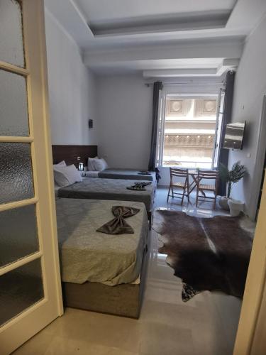 a hotel room with two beds and a window at family suites cairo downtown in Cairo
