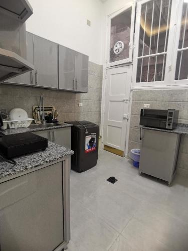 a kitchen with a trash can in the middle at family suites cairo downtown in Cairo