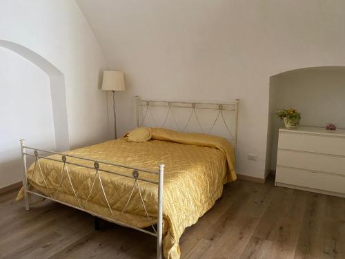 a bedroom with a bed and a dresser with a lamp at Casa Bellina in Locorotondo
