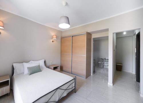 a bedroom with a bed and a walk in closet at Apricus Apartments in Apolpaina