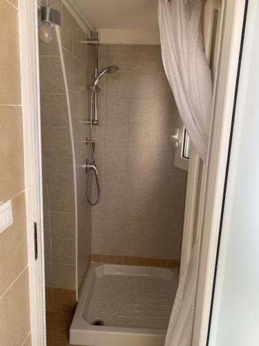 a bathroom with a shower with a toilet and a shower curtain at Casa Bellina in Locorotondo