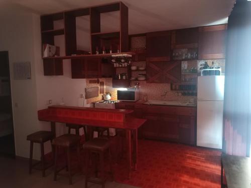 a kitchen with a red table and a refrigerator at Apartment Feral in Neum