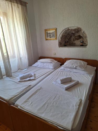 a bed with two white towels on top of it at Dora in Kraljevica