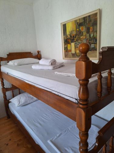 two beds in a room with a painting on the wall at Dora in Kraljevica