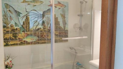 a shower with a glass door in a bathroom at Les 2 tours La Rochelle in La Rochelle