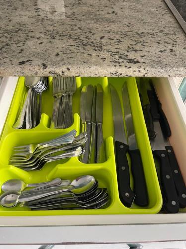 a tray of utensils in a drawer under a counter at Casa Independiente Bella Vista in Moaña