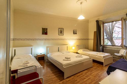 a bedroom with two beds and a table and chairs at Soggiorno Primavera in Florence
