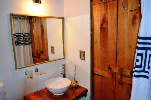 a bathroom with a sink and a mirror at Arándanos in Punta Del Diablo