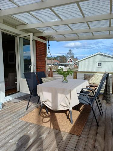 a patio with a table and chairs on a deck at Villa with hot tub and sauna in Umeå