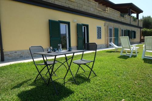 a table and chairs in the yard of a house at Villa Finocchito - The sound of silence in Ogliastro Cilento