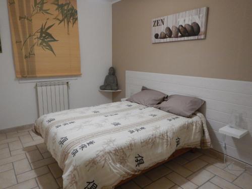 a bedroom with a bed with a comforter on it at Chambres d'hôtes naturistes adultes pour couples in Figanières