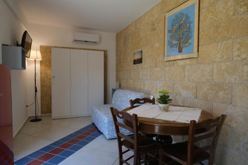 a room with a table and chairs and a door at Villa Finocchito - The sound of silence in Ogliastro Cilento