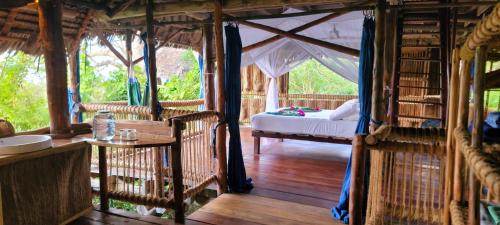 a bedroom with a bed in a tent at Chole Mjini Treehouses Lodge in Utende