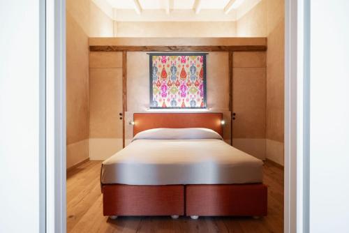 a bed in a room with a window at Guadalupe Tuscany Resort in Braccagni