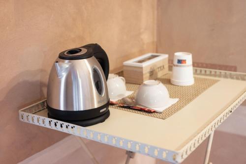 a coffee maker sitting on top of a table at Guadalupe Tuscany Resort in Braccagni