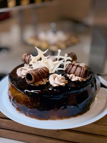 a chocolate cake on a plate on a table at Argisht Partez Hotel ALL INCLUSIVE and beach with free sunbeds on the pool & beach bar Rebls in Golden Sands
