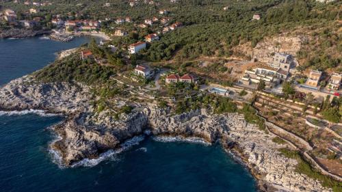 an aerial view of a rocky island in the ocean at Mani Suites in Agios Nikolaos