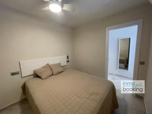 A bed or beds in a room at InmoBooking LeriMar