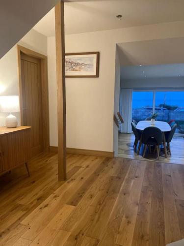 a dining room with a table and chairs in a room at Crail 5 Bedroom Villa in Crail