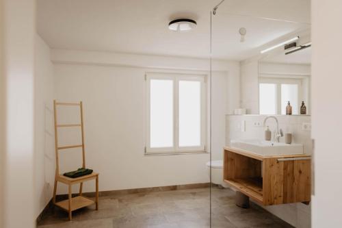 a bathroom with a sink and a glass shower at Ferienhaus Lindenglück in Löffingen