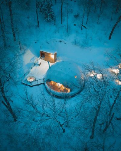 a snow covered igloo with a light in the middle at Dômes Charlevoix in Petite-Rivière-Saint-François